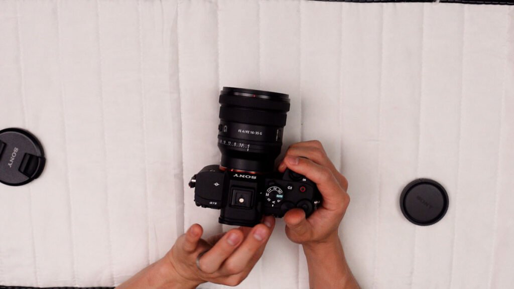 Sony 16-35mm F4 PZ wide-angle lens close-up showing black barrel zoom ring and focus ring