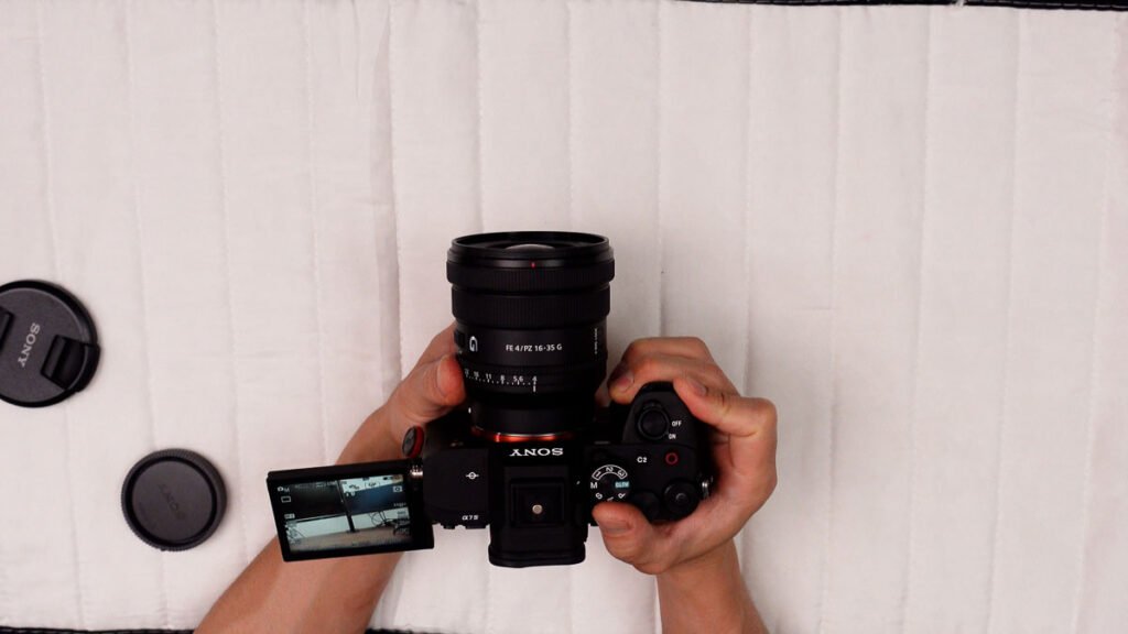Sony 16-35 F4 PZ G lens angled front view revealing wide front element and silver accent ring