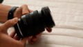 a man holding a Tamron 11-20mm f/2.8 Di III-A RXD lens