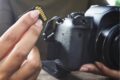 A person holding a camera and an SD card.