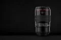 A Canon lens on a black background.