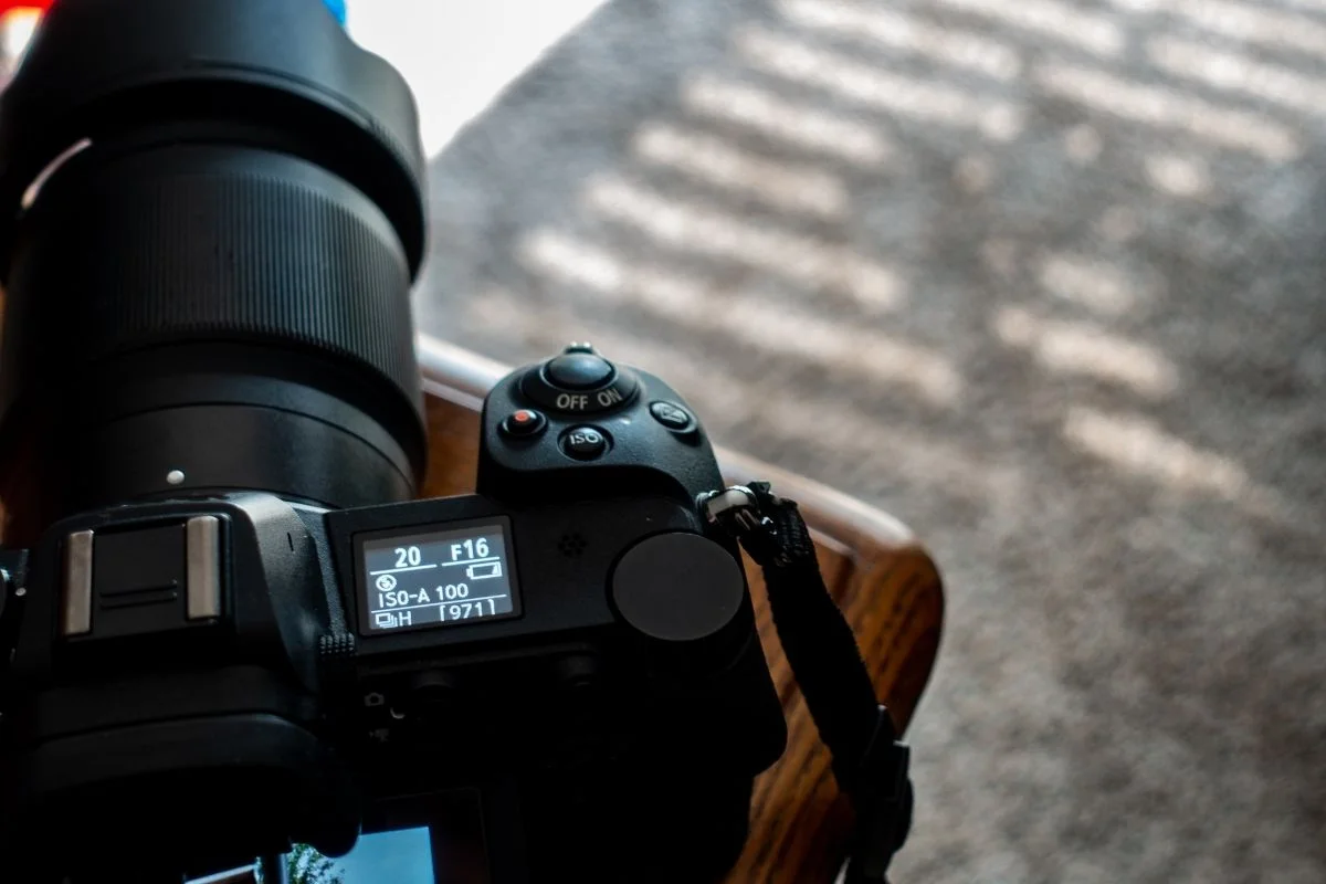 A DSLR camera showing battery charge percentage.