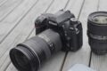 A Nikon camera on top of a wooden table.