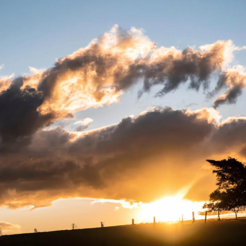 An image of a serene landscape bathed in the warm golden glow of a setting sun, with elongated shadows and a radiant sky showcasing the magic of golden hour illumination